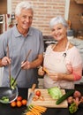 Cooking, health and smile with portrait of old couple in kitchen for salad, love and nutrition. Happy, help and Royalty Free Stock Photo