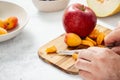 Cooking healthy diet eating. Male hands are cutting fresh fruit making summer salad Royalty Free Stock Photo