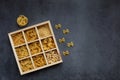 Cooking, healthy food concept. Different types of pasta in a wooden box on a dark background. View from above Royalty Free Stock Photo