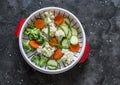 Cooking healthy food concept. Fresh vegetables broccoli, zucchini, carrots, asparagus in a steamer on a dark background, top view