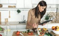 Cooking healthy food home kitchen Beautiful young woman preparing summer salad