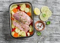 Cooking healthy food - raw ingredients: potatoes, zucchini, carrots, onions, garlic, peppers and fish sea bass in a baking dish Royalty Free Stock Photo