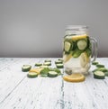 Cooking healthy lemonade with cucumber, lemon and mint on white rustic wooden background space for text