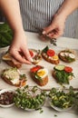 Feamale hands making healthy bruschettas for right snack Royalty Free Stock Photo