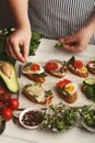 Feamale hands making healthy bruschettas for right snack Royalty Free Stock Photo