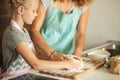 Cooking and home concept - close up of female hands kneading dough at home Royalty Free Stock Photo