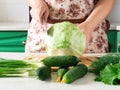 Cooking and home concept-close-up of a woman`s hands cutting cabbage on a cutting Board with a sharp knife. Royalty Free Stock Photo