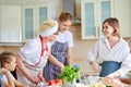 Cooking at Home. Family having fun together. Grandmother and kids making meal Royalty Free Stock Photo