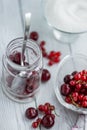 Cooking at home jam from red summer berries, currants and cherries, Glass dishes on a light background, shot from above Royalty Free Stock Photo