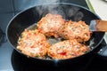 Cooking home made meatballs with vegetables in pan on ceramic st Royalty Free Stock Photo