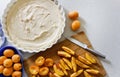 Cooking homemade apricot pie. Slices of fresh apricots for pie on a cutting board, dough in a white baking dish. Royalty Free Stock Photo