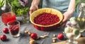Cooking homemade cranberry pie. In the baking dish with the dough, put a spoon of fresh cranberries Royalty Free Stock Photo