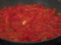 Cooking homemade tomato sauce using fresh summer tomatoes, onion and garlic . Italian recipe Royalty Free Stock Photo