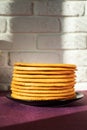 Cooking honey cake at home. Round baked cake layers stacked on a plate