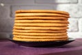 Cooking honey cake at home. Round baked cake layers stacked on a plate