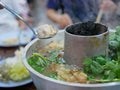 Cooking hot pot with hot charcoals in the middle, originally from Yunnan, China, adapted and cooked tastier in the North of Royalty Free Stock Photo