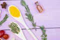 Cooking Hot Spicy Food Concept. Dry spices,beans and herbs in plastic cup, glass jar with cork and wooden spoon, purple wooden bac Royalty Free Stock Photo