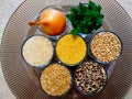 Cooking ingredients and cereal crops in clear glass cups in circular arrangement