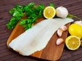 Raw atlantic cod fillet on wooden table Royalty Free Stock Photo