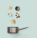 Cooking ingredients, italian risotto with wild mushrooms isolated on blue Royalty Free Stock Photo