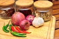 Cooking ingredients. Spice and herbs with onion and garlic on wooden board Royalty Free Stock Photo