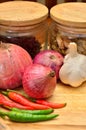 Cooking ingredients. Spice and herbs with onion and garlic on wooden board Royalty Free Stock Photo