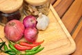 Cooking ingredients. Spice and herbs with onion and garlic on wooden board Royalty Free Stock Photo