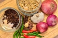 Cooking ingredients. Spice and herbs with onion and garlic on wooden board Royalty Free Stock Photo