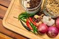 Cooking ingredients. Spice and herbs with onion and garlic on wooden board Royalty Free Stock Photo