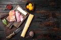 Cooking italian food collage. Ingredients for carbonara pasta, spaghetti, oil, ham, egg and parmesan, on old dark  wooden table , Royalty Free Stock Photo