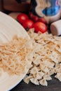 cooking italian pasta by hand kitchen cherry tomatoes ingredients lunch