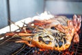 Cooking king prawns grilled on the flaming grill Royalty Free Stock Photo