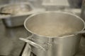 Cooking in the kitchen. An aluminum pot is steaming on an electric stove. Royalty Free Stock Photo