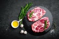 Cooking on kitchen table fresh raw pork marbled steaks on black background Royalty Free Stock Photo