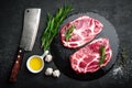 Cooking on kitchen table fresh raw pork marbled steaks on black background Royalty Free Stock Photo