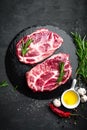 Cooking on kitchen table fresh raw pork marbled steaks on black background Royalty Free Stock Photo