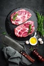 Cooking on kitchen table fresh raw pork marbled steaks on black background Royalty Free Stock Photo