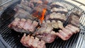 Cooking large juicy pieces of raw fatty natural marinated pork meat beef calves on a griddle grill. American barbecue in Royalty Free Stock Photo