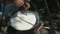 Cooking in a Large Pot Outdoors, Person stirring with a wooden spoon in a large pot over an open fire.