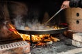 Cooking and making a traditional Spanish Paella over open fire