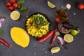 Cooking mango salsa - sliced chopped ingredients in a black ceramic bowl