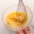 Making of mixing eggs in bowl on marble table as homemade food flat lay, top view food brand photography flatlay and recipe for