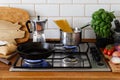 Cooking meal on a gas stove in traditional home kitchen. Wood worktop.