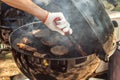 Cooking meat for burgers and cheeseburgers, sausages for hot dogs, buns on a grill with burning coals.