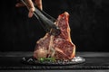 Cooking meat by chef hands raw porterhouse steak, dry-aged with herbs, pepper and salt. menu restaurant or recipe text Royalty Free Stock Photo