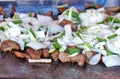 Cooking Meat and Onions on a Griddle