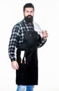 Cooking meat in park. Bearded hipster wear apron for barbecue. Roasting and grilling food. Man hold cooking utensils Royalty Free Stock Photo