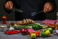 Cooking meat steak, vegetables and spices with by chef hands on wooden background. Food recipe concept Royalty Free Stock Photo