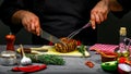 Cooking meat steak, vegetables and spices with by chef hands on wooden background. Food recipe concept Royalty Free Stock Photo