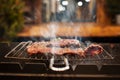 Cooking meat steaks on the fire on the grill at night. defocus. smoke Royalty Free Stock Photo